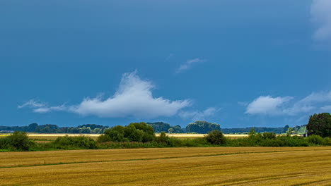 time lapse view of beautiful blue sky with white over plowed spring field on a sunny day