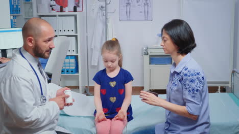 pediatrician giving mother a bottle of pills