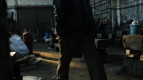 worker in a dark industrial workshop