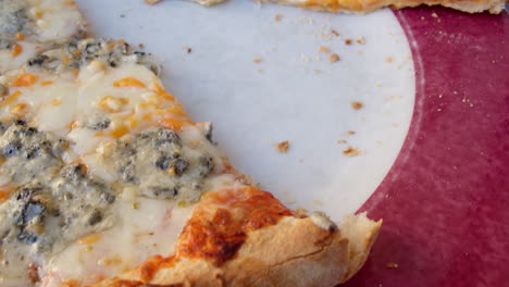 child taking a slice of pizza