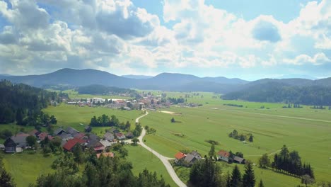 aerial view to the small slovenia village in the mountains with some beautiful field