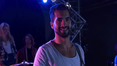 Musician-looking-at-camera-and-smiling