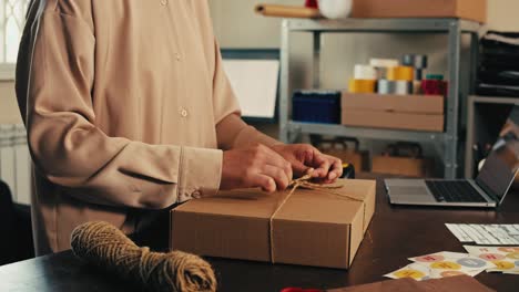 woman packing and preparing a gift box for shipping