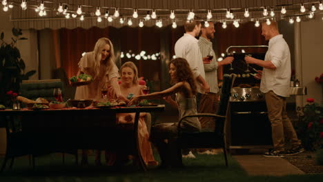 cheerful friends enjoying barbeque party on backyard