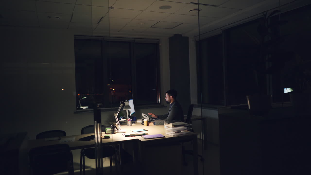Employee Working Late at Night in Office