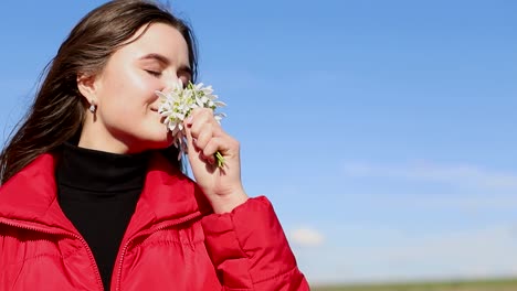 beautiful smiling brunette girl holding bouquet of snowdrops first spring flowers beautiful smiling brunette girl holding bouquet of snowdrops first spring flowers girl holding flowers and smiling to camera spring flowers