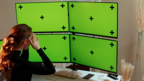 Young woman, multiple green screen computer monitors with tracking