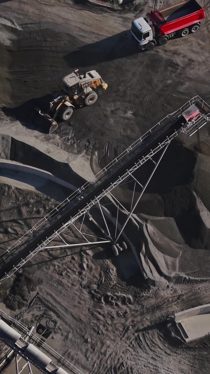 Mining activities in a quarry site with machinery and materials
