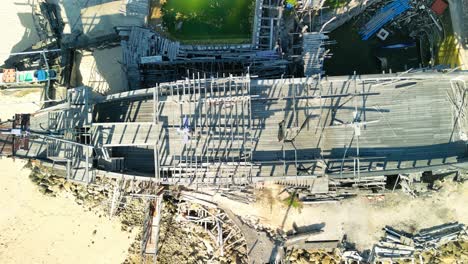 Aerial-over-Melasti-Beach,-the-southernmost-beach-on-the-island-of-Bali-in-Indonesia,-view-of-a-ship-on-the-shore-of-the-southernmost-point-in-Bali,-bird-eye-drone-view-of-a-ship-on-the-shore