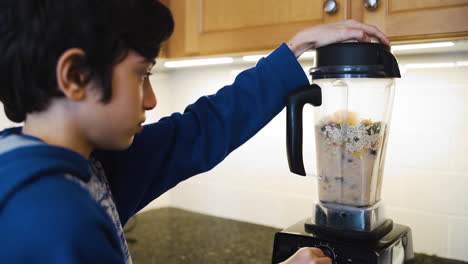 Young-boy-blending-a-fruit-smoothie-in-slow-motion