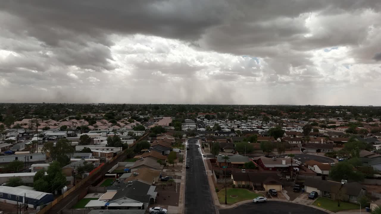 Flying Over Neighborhood in southwest, Extremely cloudy, Dust Storm in the Distance, Chandler Arizona in late September, aerial view