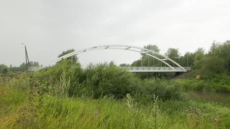 white metal bridge crossing a stream