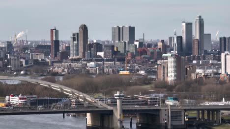 aerial panning view of rotterdam netherlands with the van brienenoord bridge over the nieuwe maas river, with vehicle traffic