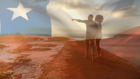 animation of flag of chile over african american couple at beach