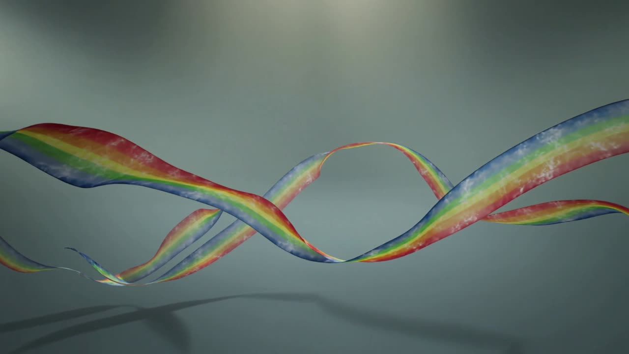 First frame arc starting rainbow ribbons swaying in gray studio under spotlight casting shadows