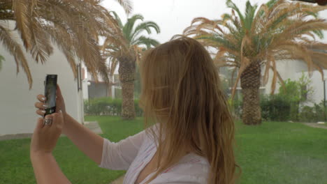 young woman taking selfie on rainy day