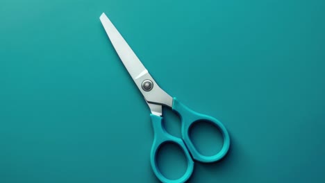 blue handled scissors on teal background in minimalist style