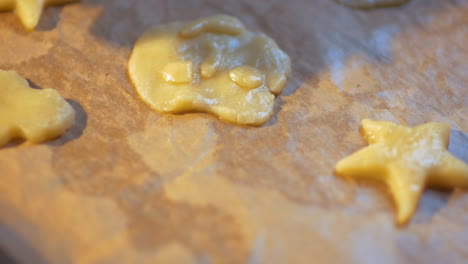 woman puts pastry dough molds on the paper