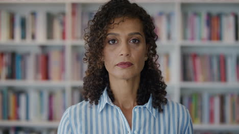 close-up-portrait-mature-mixed-race-business-woman-looking-confident-successful-female-entrepreneur-in-bookshelf-background-slow-motion