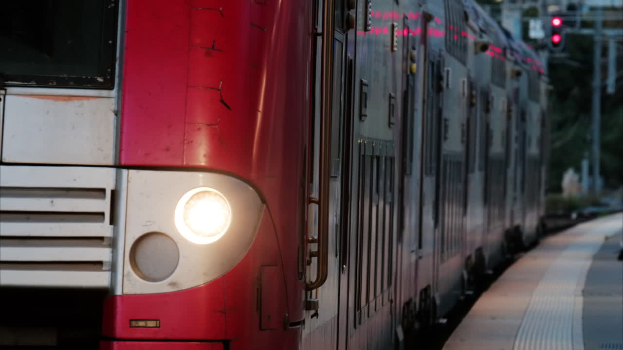 Grasse, France - November 21, 2024: Red train slowly arriving at the station