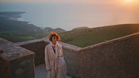 woman walking stairs sunset coastline enjoying nature beauty. lady posing coast