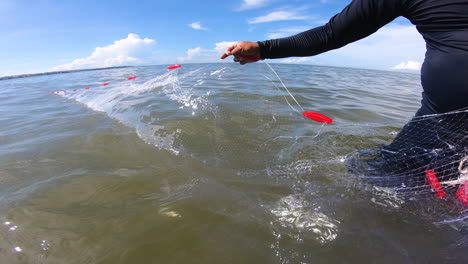 pov, man pulling out fishing gill net from ocean