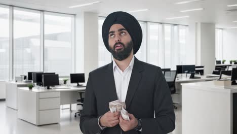 sikh indian businessman counting money