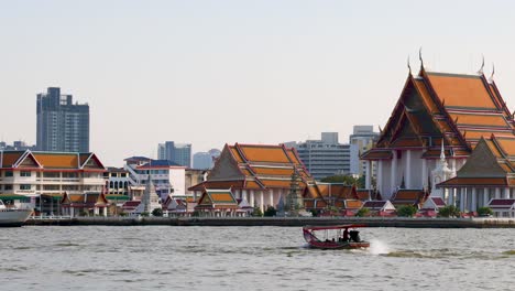 traditional boats moving along a bustling riverfront