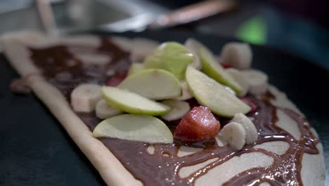 adding apple on to the crepe