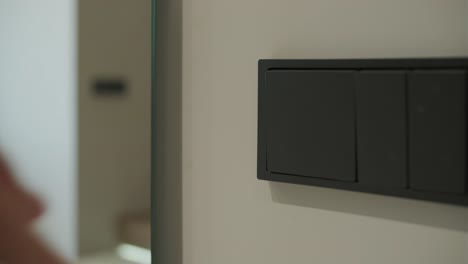 hand switching off modern black light switch