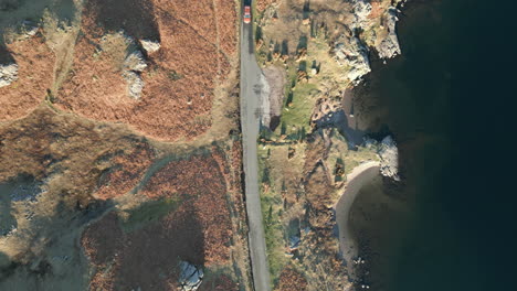 Top-down-lakeside-road-with-traffic-on-moorland-in-winter-at-Wasdale-Lake-District-UK