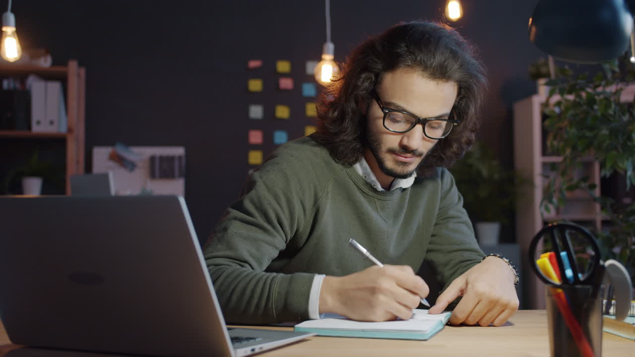 Young Man Working Late at Night in Office