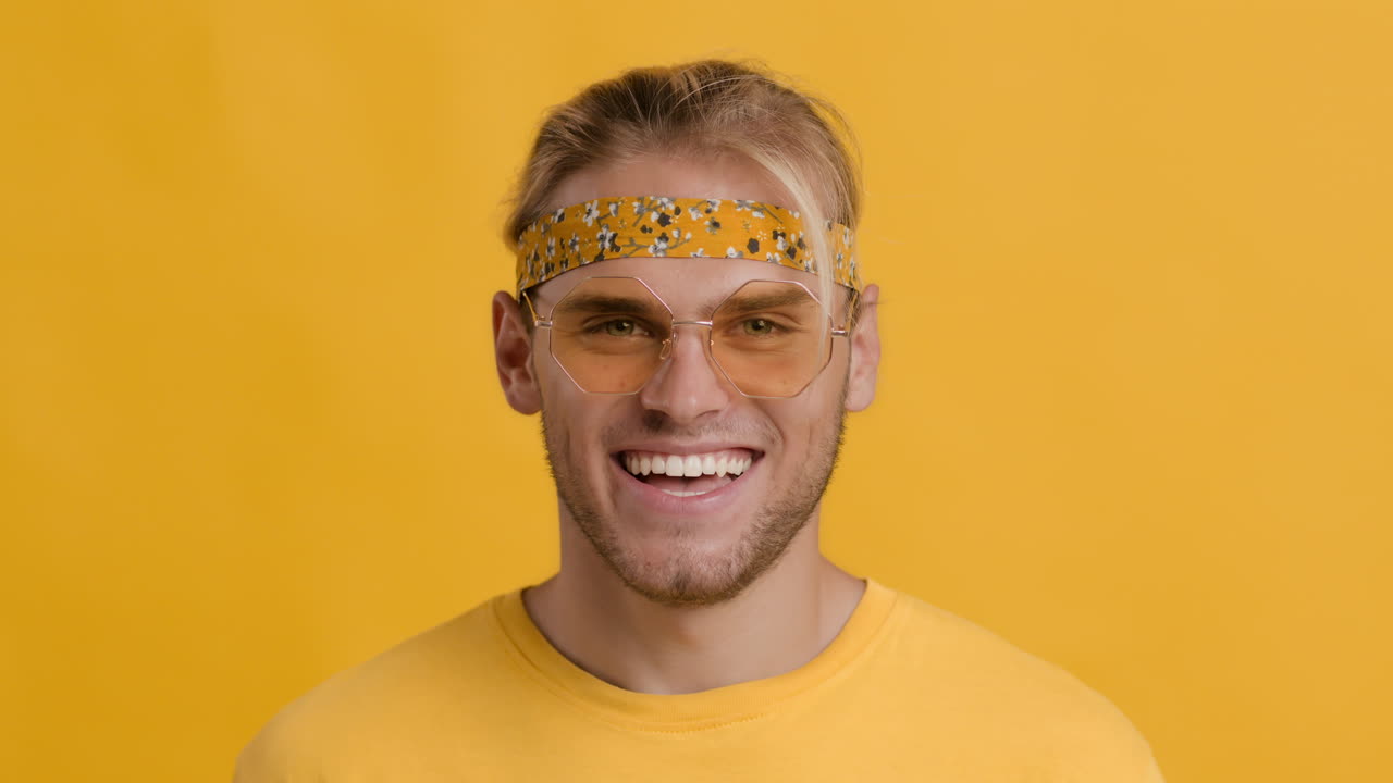 Man Wearing a Yellow Bandana, Glasses, and Yellow Shirt