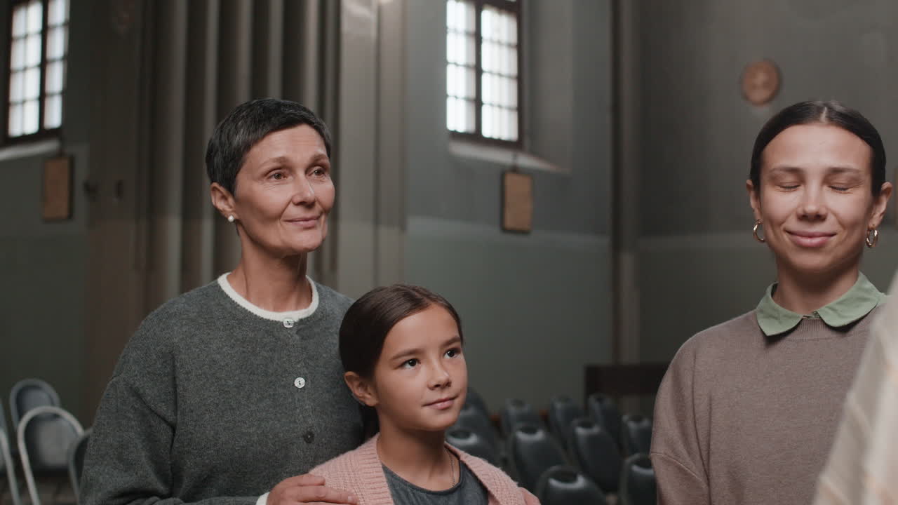 Three generations of women in a church