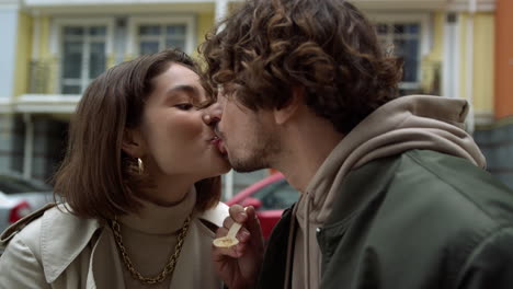 affectionate couple feeding each other outdoor