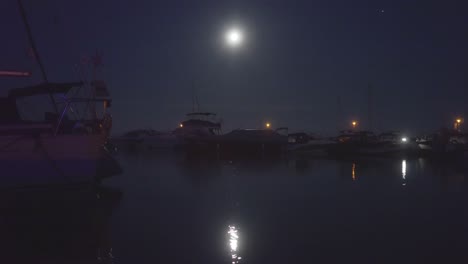 still shot of a boats floating calmly in a moonlight