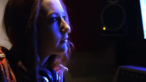 Female-audio-engineer-looking-at-computer-screen