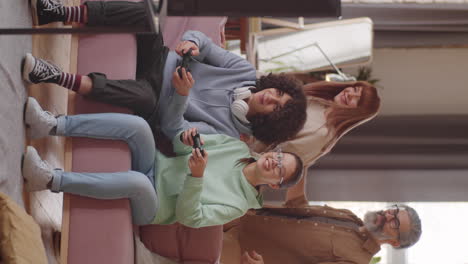 happy teenage children playing video game with support of parents