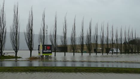 driving on flooded street in abbotsford, bc, canada after heavy rainstorm