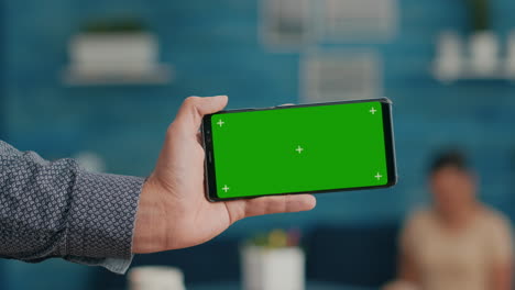 Front-view-of-horizontal-isolated-mock-up-green-screen-chroma-key-display-of-modern-smartphone