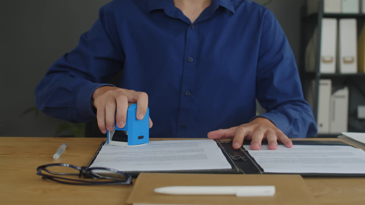 Entrepreneur Signing Agreement and Putting Stamp at Office