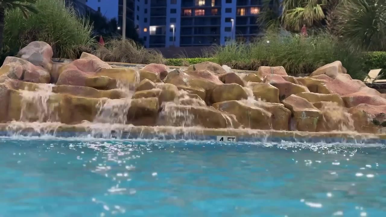 Rock waterfall flowing into a swimming pool at a resort in Myrtle Beach South Carolina.