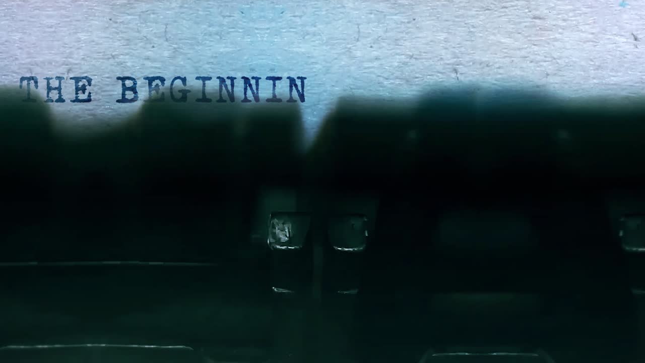 The beginning word closeup being typing and centered on a sheet of paper on old vintage typewriter