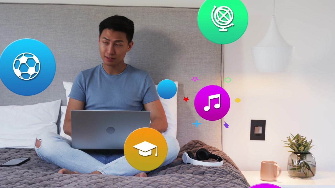 Man tapping smartphone then typing on laptop, watching colorful app icons floating for education