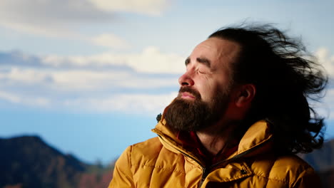 adventure seeker struggling with extreme cold winds on a mountain peak