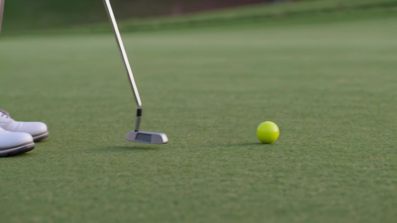 Palla da golf giallo neon che rotola verso la buca dopo il colpo del putter da parte di un golfista in pantaloni beige