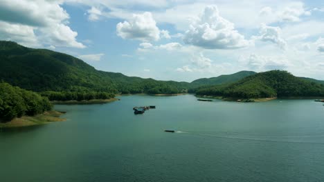 4k cinematic nature aerial footage of a drone flying over the beautiful lake and mountains of srilanna national park in chiang mai, thailand on a sunny day