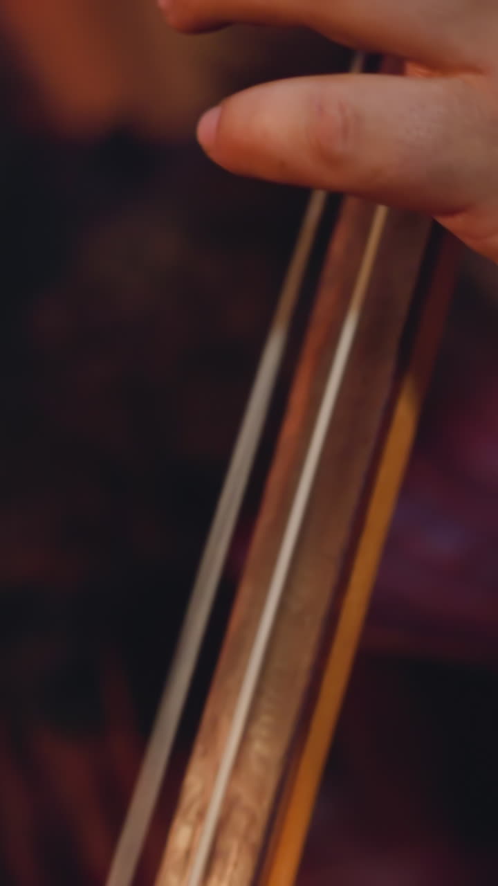 Fat bearded man plays tovshuur at folk music concert focus on hand and instrument neck. Altai musical rituals. Entertainment at ethnic festival