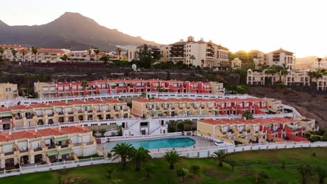 scenic sunrise over tenerife’s costa adeje with terraced resorts and mountains