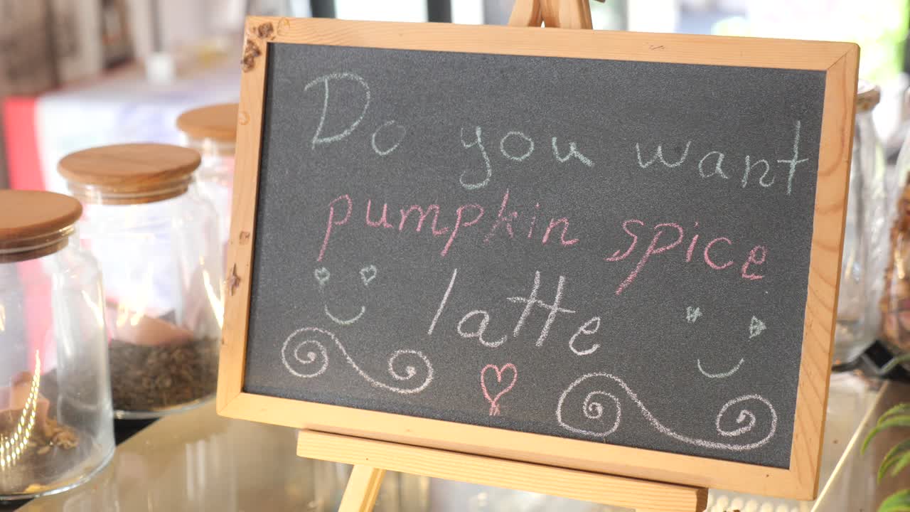 Chalkboard sign offering pumpkin spice latte